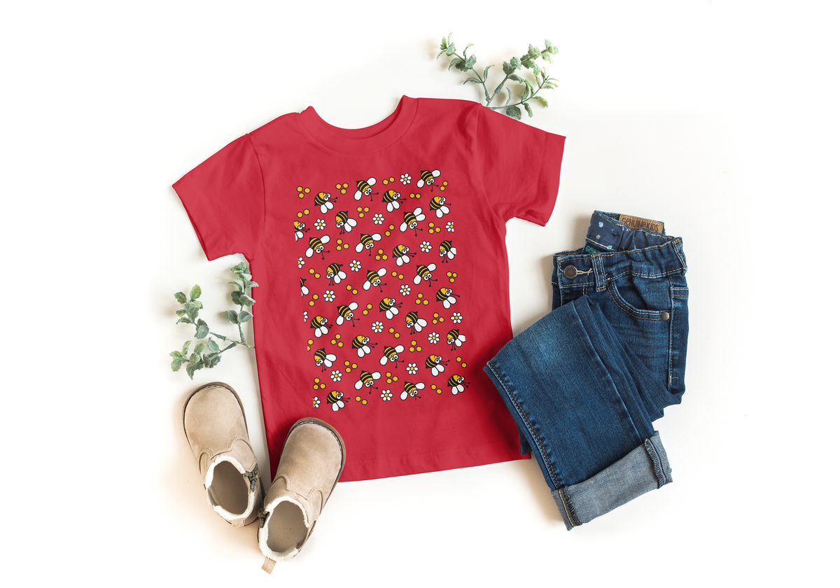 Red kids t-shirt with all-over flying bees and daisy print, styled with jeans and boots - Marfz.pk
