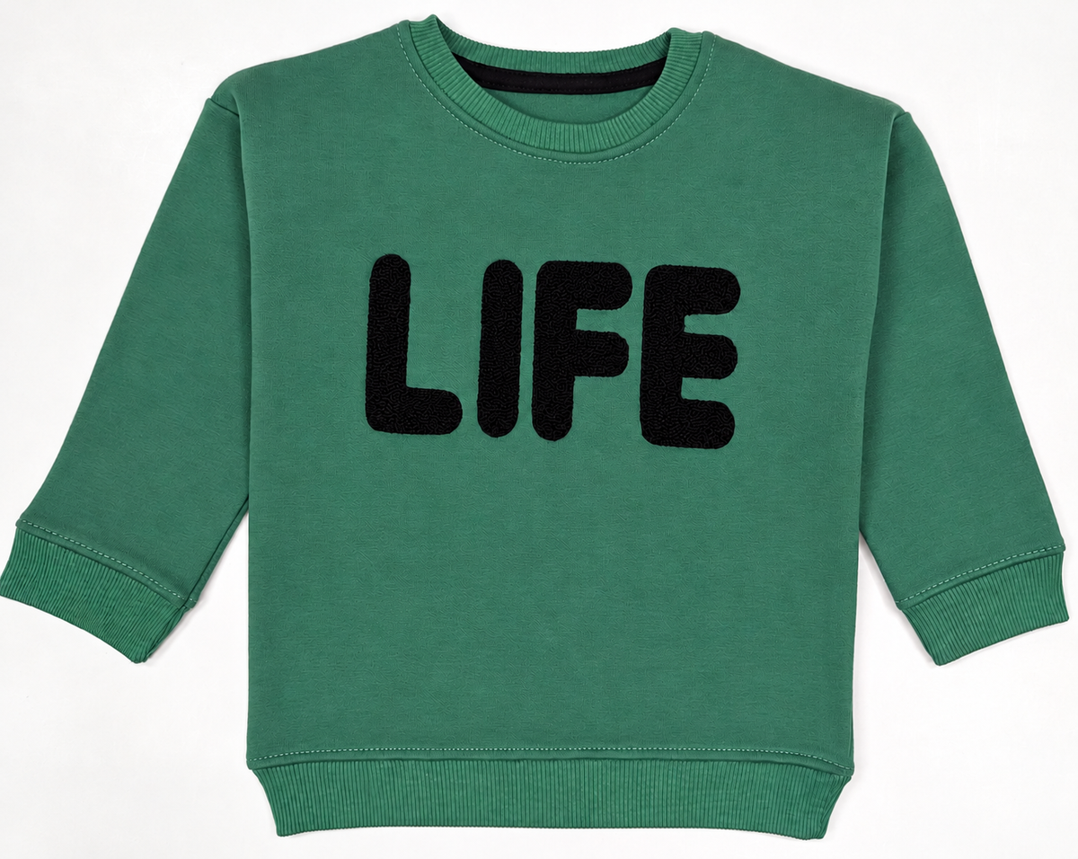 Green fleece sweatshirt for babies and toddlers with black textured LIFE lettering, round neck, long sleeves and ribbed cuffs – front view.