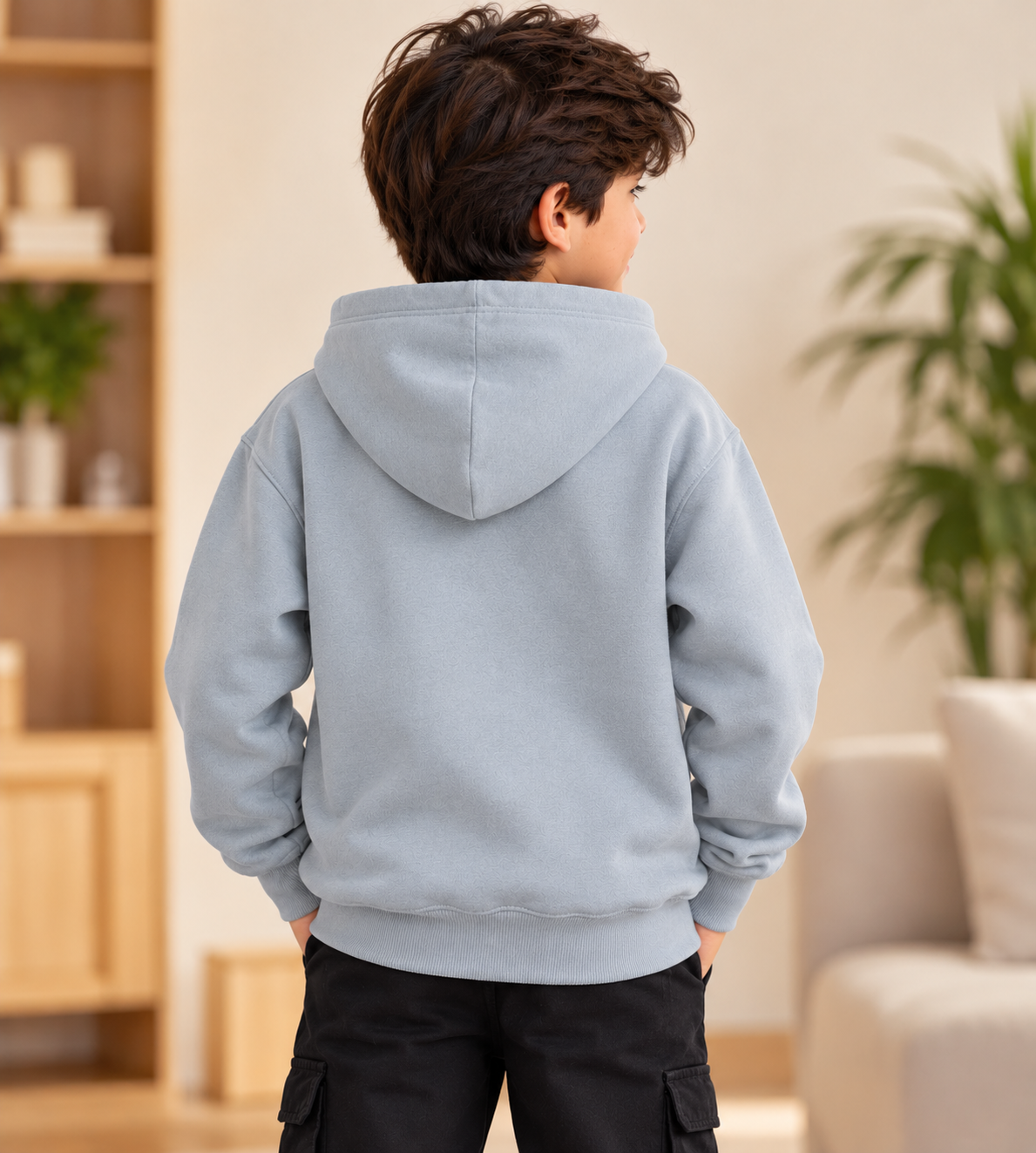 Boy wearing a grey fleece winter hoodie with attached hood, plain back design, long sleeves and ribbed hem – back view