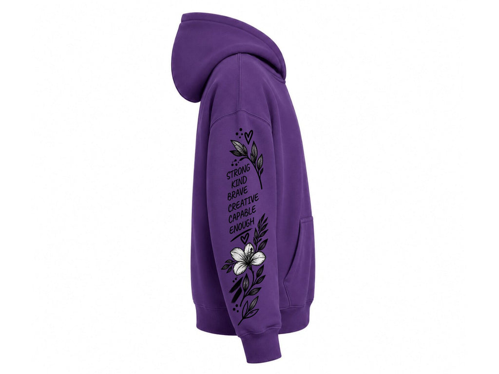 A purple pullover hoodie shown from the side profile on a plain white background, featuring a black and white graphic print on the sleeve with text and floral details.